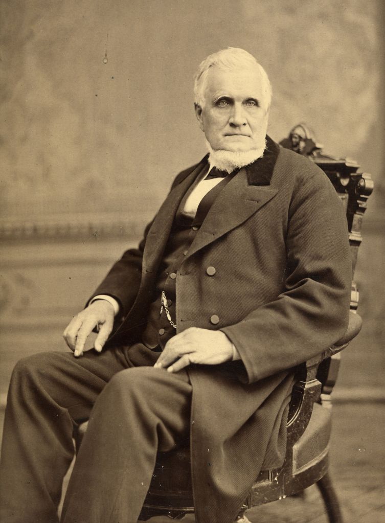 John_Taylor_seated_in_chair